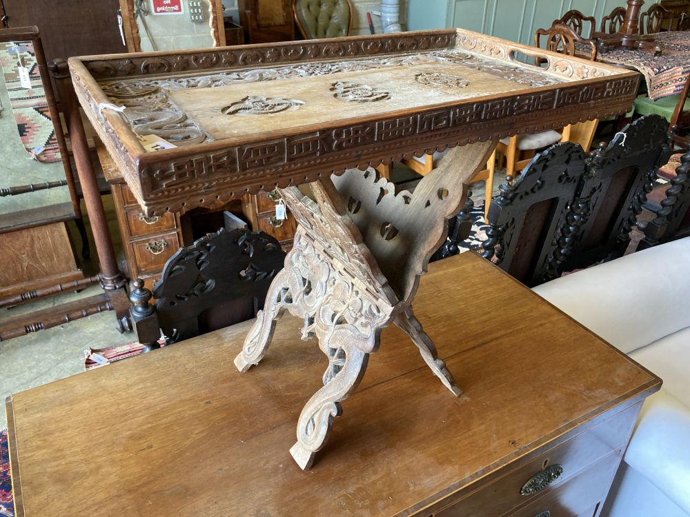 A WWI Sino-Burmese carved teak tray on folding stand,